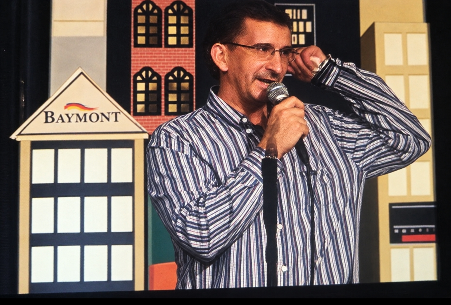 Founder performing stand-up comedy